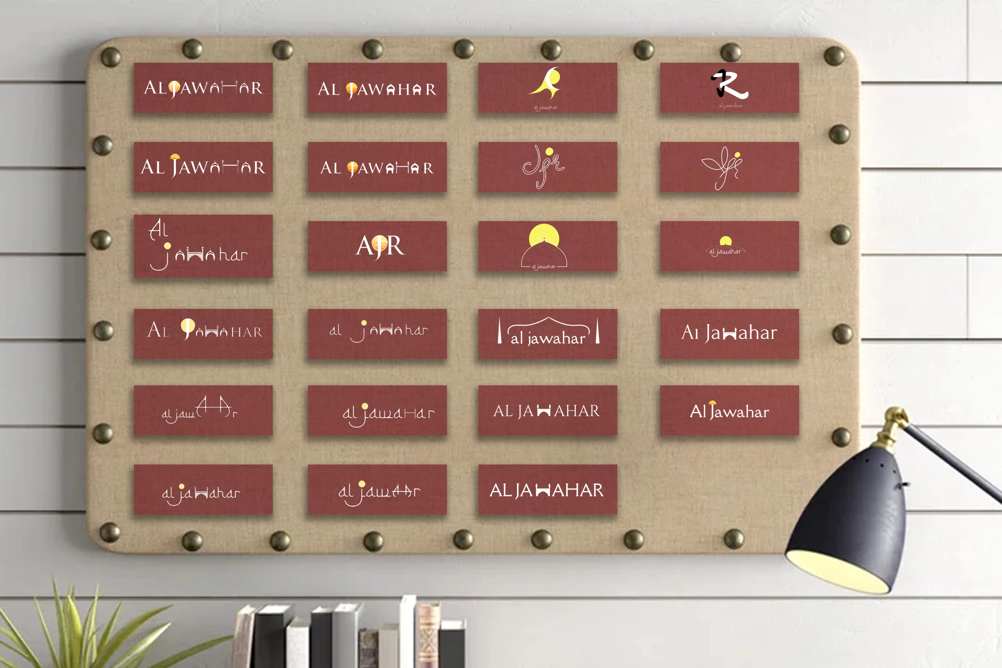 Board showing the logo exploration process and multiple Al Jawahar wordmark directions