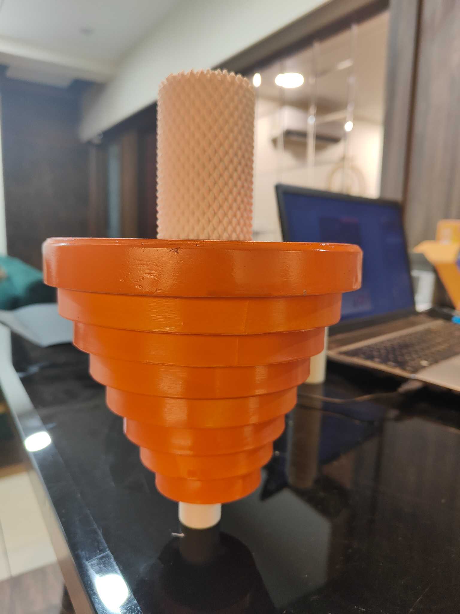 Orange physical prototype testing the nested stepped layers of Eclipse